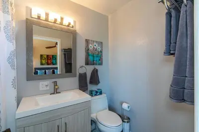 a bathroom with a sink and a toilet and a mirror at The Zen House Temecula in Temecula