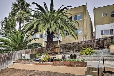a palm tree in front of a building at Little Italy Apt in San Diego
