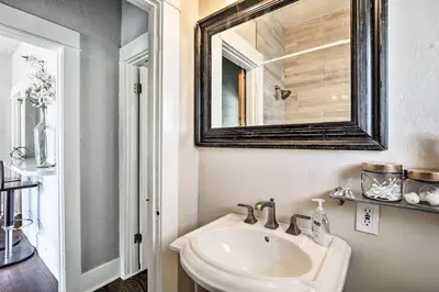 a bathroom with a sink and a mirror at Little Italy Apt in San Diego