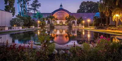 a large building with a pond in front of it at Little Italy Apt in San Diego