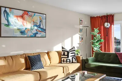 a living room with a couch and a table at Bayside Bliss House - Pool Spa Views in San Diego