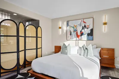 a bedroom with a large white bed and windows at Bayside Bliss House - Pool Spa Views in San Diego