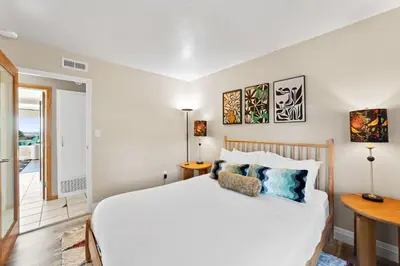 a bedroom with a large white bed and a table at Bayside Bliss House - Pool Spa Views in San Diego