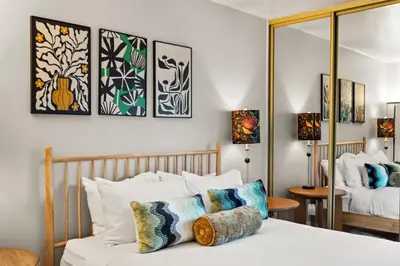 a bedroom with a bed with pillows on it at Bayside Bliss House - Pool Spa Views in San Diego