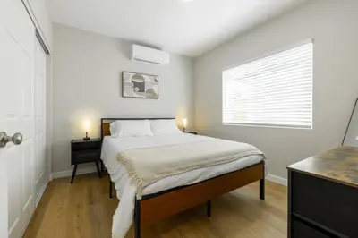 a bedroom with a large bed and a window at Cozy Casa | Sleek & Modern Monthly Escape in Santee
