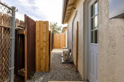 an entrance to a house with a fence at Cozy Casa | Sleek & Modern Monthly Escape in Santee