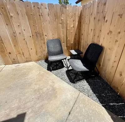 two chairs sitting in front of a fence at Cozy Casa | Sleek & Modern Monthly Escape in Santee