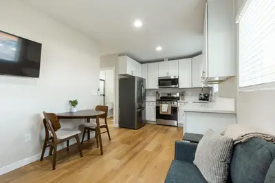 a kitchen and living room with a table and a couch at Cozy Casa | Sleek & Modern Monthly Escape in Santee