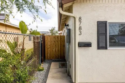 a gate to a house with a fence at Cozy Casa | Sleek & Modern Monthly Escape in Santee