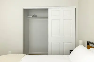 a bedroom with a white closet with a white door at Cozy Casa | Sleek & Modern Monthly Escape in Santee