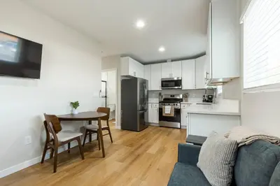 a kitchen and living room with a table and a couch at Cozy Casa | Sleek & Modern Monthly Escape in Santee