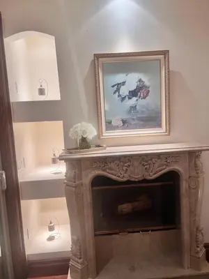 a fireplace with a picture on top of it at The Chateau Escondido in Escondido