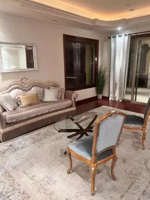a living room with a couch and a table and a chair at The Chateau Escondido in Escondido