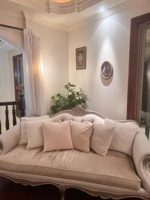 a white couch with pillows in a living room at The Chateau Escondido in Escondido