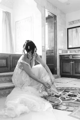 a woman in a wedding dress sitting on the floor at The Chateau Escondido in Escondido