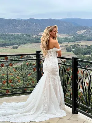a woman in a wedding dress standing on a balcony at The Chateau Escondido in Escondido