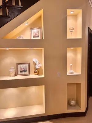 a wall of shelves in a living room with vases at The Chateau Escondido in Escondido
