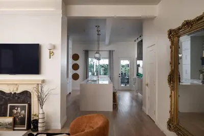 a living room with a fireplace and a mirror at Luxe Victorian Retreat • Walk to Downtown in San Diego
