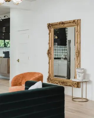 a living room with a mirror and a couch at Luxe Victorian Retreat • Walk to Downtown in San Diego