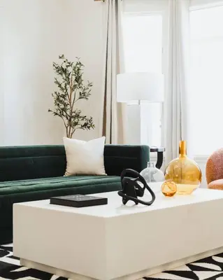 a living room with a green couch and a white coffee table at Luxe Victorian Retreat • Walk to Downtown in San Diego