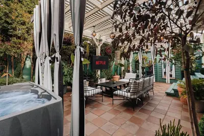 a patio with a hot tub and a table and chairs at Luxe Victorian Retreat • Walk to Downtown in San Diego