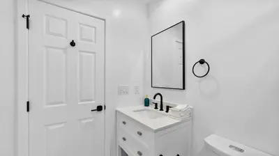 a white bathroom with a sink and a mirror at Central Spot - 4 Min to Waterpark, Dining & Shops in Vista