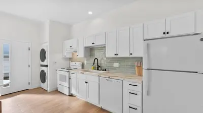 a white kitchen with a sink and a refrigerator at Central Spot - 4 Min to Waterpark, Dining & Shops in Vista