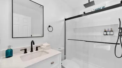 a white bathroom with a shower and a sink at Central Spot - 4 Min to Waterpark, Dining & Shops in Vista