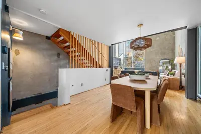 a dining room with a table and a couch at Gaslamp Row House - Sleeps 8 Private Garage AC in San Diego