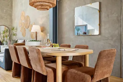 a dining room with a wooden table and chairs at Gaslamp Row House - Sleeps 8 Private Garage AC in San Diego