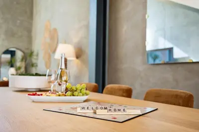 a table with a plate of grapes and a bottle of wine at Gaslamp Row House - Sleeps 8 Private Garage AC in San Diego