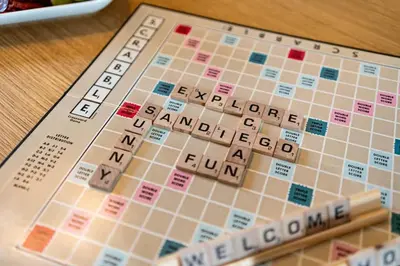 a scrabble game on a table with a cigarette at Gaslamp Row House - Sleeps 8 Private Garage AC in San Diego