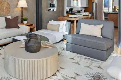 a living room with a couch and a chair and a table at Gaslamp Row House - Sleeps 8 Private Garage AC in San Diego