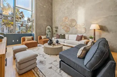 a living room with a couch and a table at Gaslamp Row House - Sleeps 8 Private Garage AC in San Diego