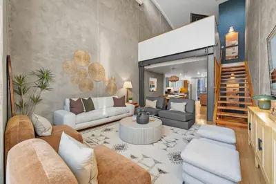 a living room with couches and a stairway at Gaslamp Row House - Sleeps 8 Private Garage AC in San Diego