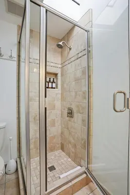 a shower with a glass door in a bathroom at Oceanview Mission Beach Compound, Balcony, Patio, Fire Pit, BBQ, Steps to Sand in San Diego
