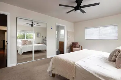 a bedroom with a bed and a ceiling fan at SoCal Living w/ Pool, hot tub and movie theater in San Diego