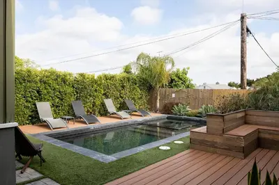 a backyard with a swimming pool and lounge chairs at SoCal Living w/ Pool, hot tub and movie theater in San Diego