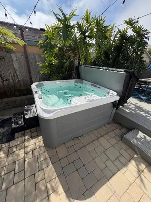 a hot tub sitting on a patio with plants at Point Loma Hideaway Relaxing Hot Tub & AC in San Diego