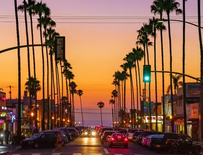 a busy city street with palm trees and a green traffic light at Point Loma Hideaway Relaxing Hot Tub & AC in San Diego
