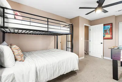 a bedroom with a bunk bed and a ceiling fan at Point Loma Hideaway Relaxing Hot Tub & AC in San Diego