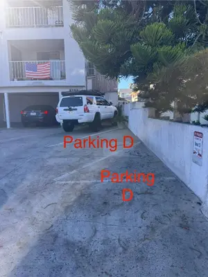 a car parked in a parking lot next to a building at Point Loma Hideaway Relaxing Hot Tub & AC in San Diego