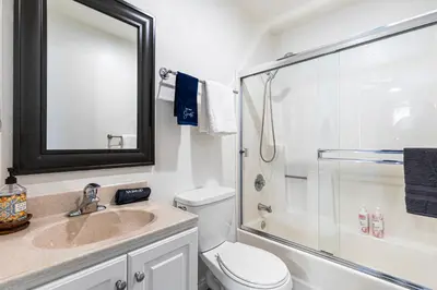 a bathroom with a toilet and a sink and a shower at Point Loma Hideaway Relaxing Hot Tub & AC in San Diego
