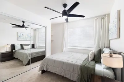 a bedroom with a bed and a ceiling fan at San Diego Private Pool Oasis Modern 3BR 2BA in San Diego
