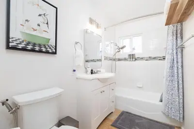 a bathroom with a sink and a toilet and a mirror at San Diego Private Pool Oasis Modern 3BR 2BA in San Diego