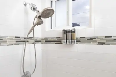 a shower with a shower head in a bathroom at San Diego Private Pool Oasis Modern 3BR 2BA in San Diego