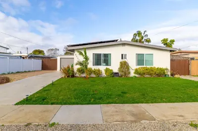 a white house with a green yard at San Diego Private Pool Oasis Modern 3BR 2BA in San Diego