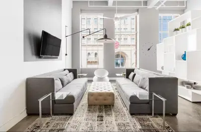 a living room with a couch and a tv at Historic Gaslamp Loft with Peloton Bike and Roof Deck in San Diego