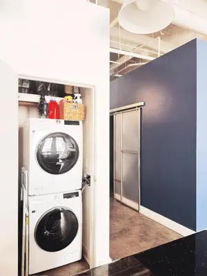 a washer and dryer in a room at Historic Gaslamp Loft with Peloton Bike and Roof Deck in San Diego