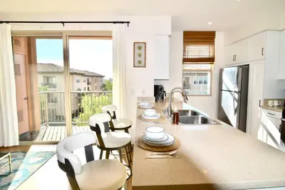 a kitchen with white appliances and a large window at Stylish 2BR Foothill Escape in Irvine in Lake Forest
